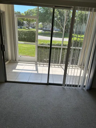 a view of an empty room and a floor to ceiling window