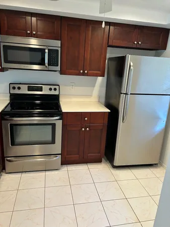 a kitchen with granite countertop a cabinets and steel stainless steel appliances