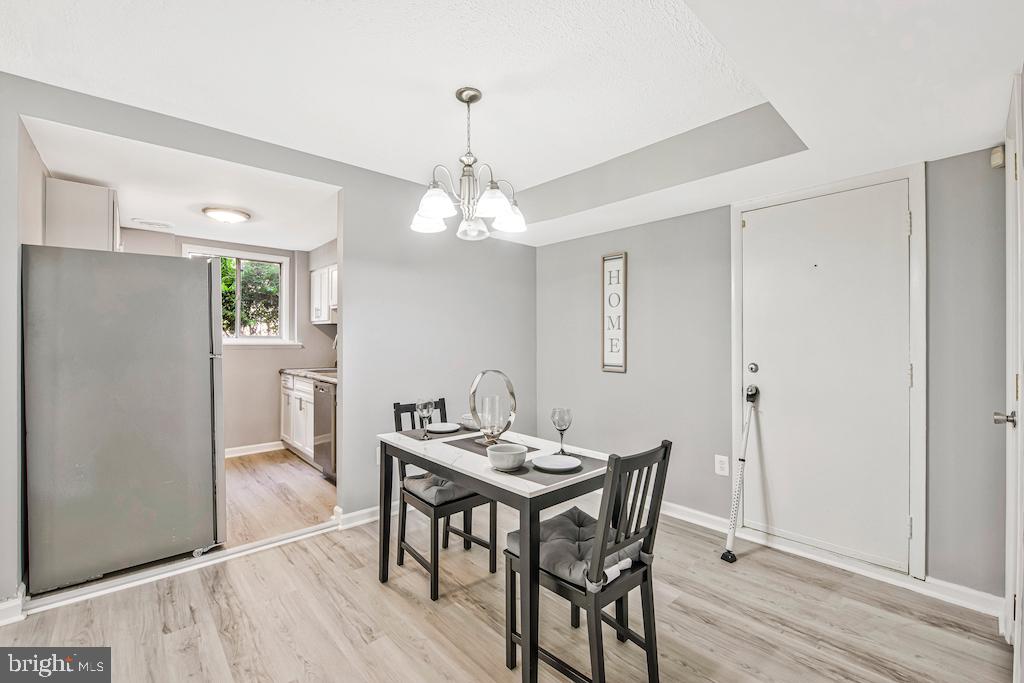 7129 Donnell Place, Unit A District Heights, MD 20747 - Photo 11 of 25 a view of a dining room with furniture and wooden floor