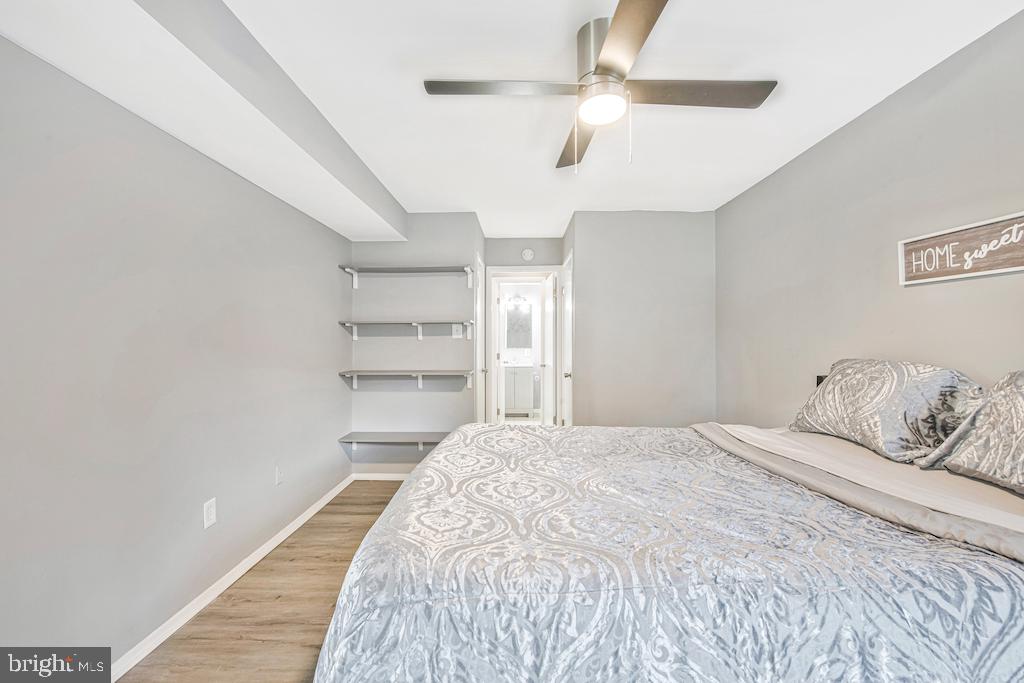 7129 Donnell Place, Unit A District Heights, MD 20747 - Photo 17 of 25 a bedroom with a bed and a ceiling fan
