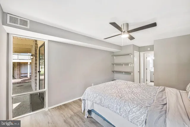 a bedroom with a large bed and a window