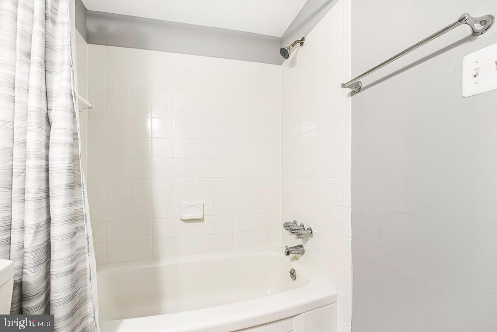 7129 Donnell Place, Unit A District Heights, MD 20747 - Photo 21 of 25 a white bath tub with shower curtain