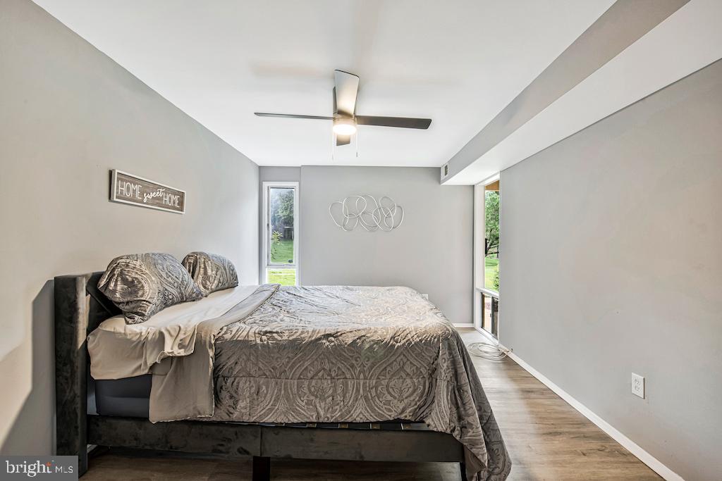 7129 Donnell Place, Unit A District Heights, MD 20747 - Photo 24 of 25 a bedroom with a bed and wooden floor