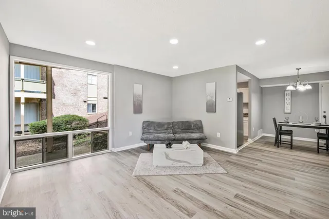 a large white room with a large window and furniture
