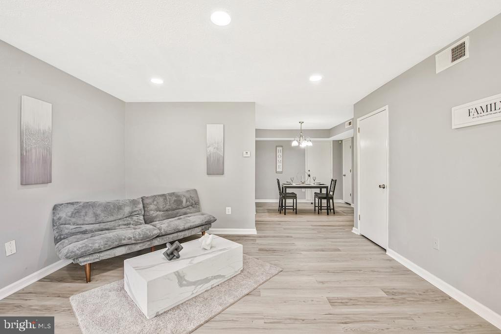 7129 Donnell Place, Unit A District Heights, MD 20747 - Photo 7 of 25 a living room with furniture and a dining table with kitchen view