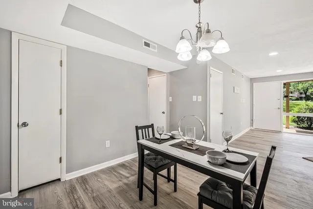 a view of a dining room with a table and chairs