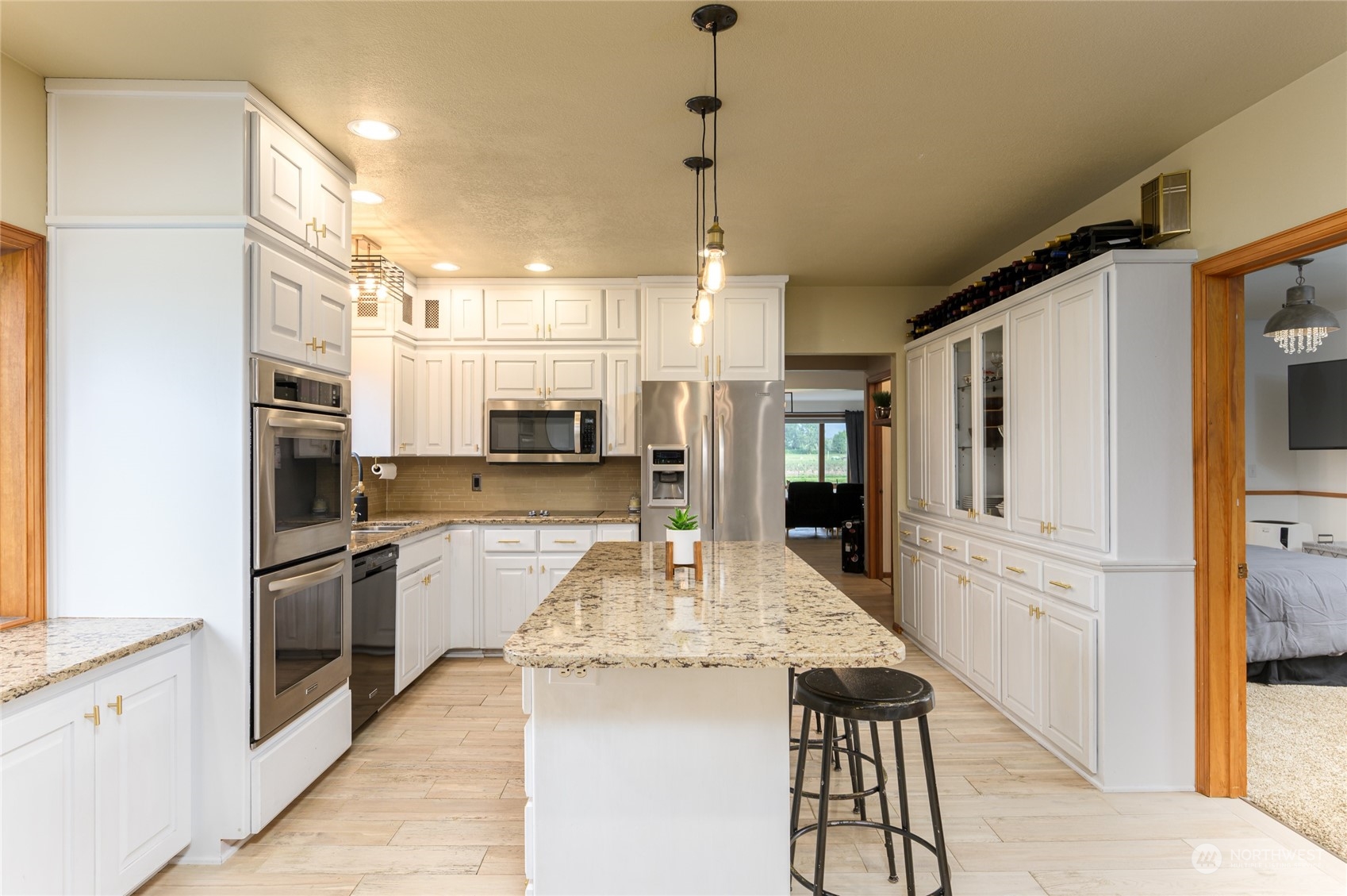 7956 Trapline Road Everson, WA 98247 - Photo 11 of 40 a kitchen with stainless steel appliances kitchen island granite countertop a refrigerator and a stove top oven