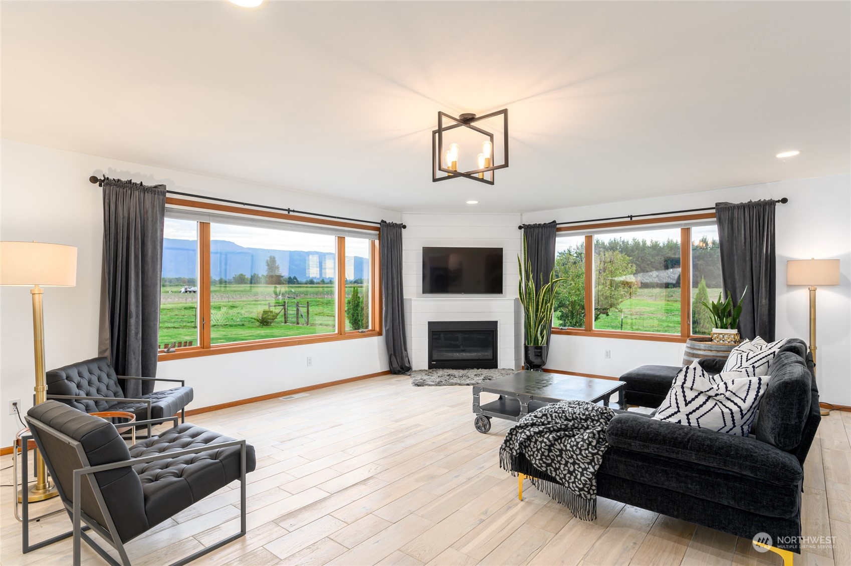 7956 Trapline Road Everson, WA 98247 - Photo 12 of 40 a living room with furniture a flat screen tv and a large window