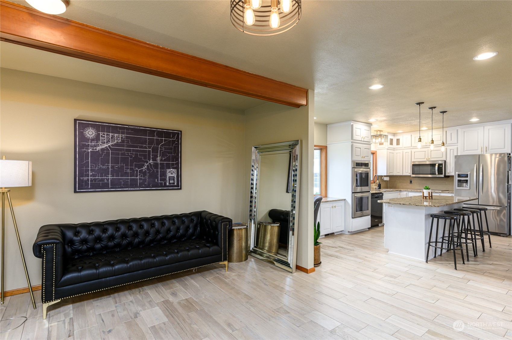 7956 Trapline Road Everson, WA 98247 - Photo 17 of 40 a living room with a couch and a dining table with wooden floor
