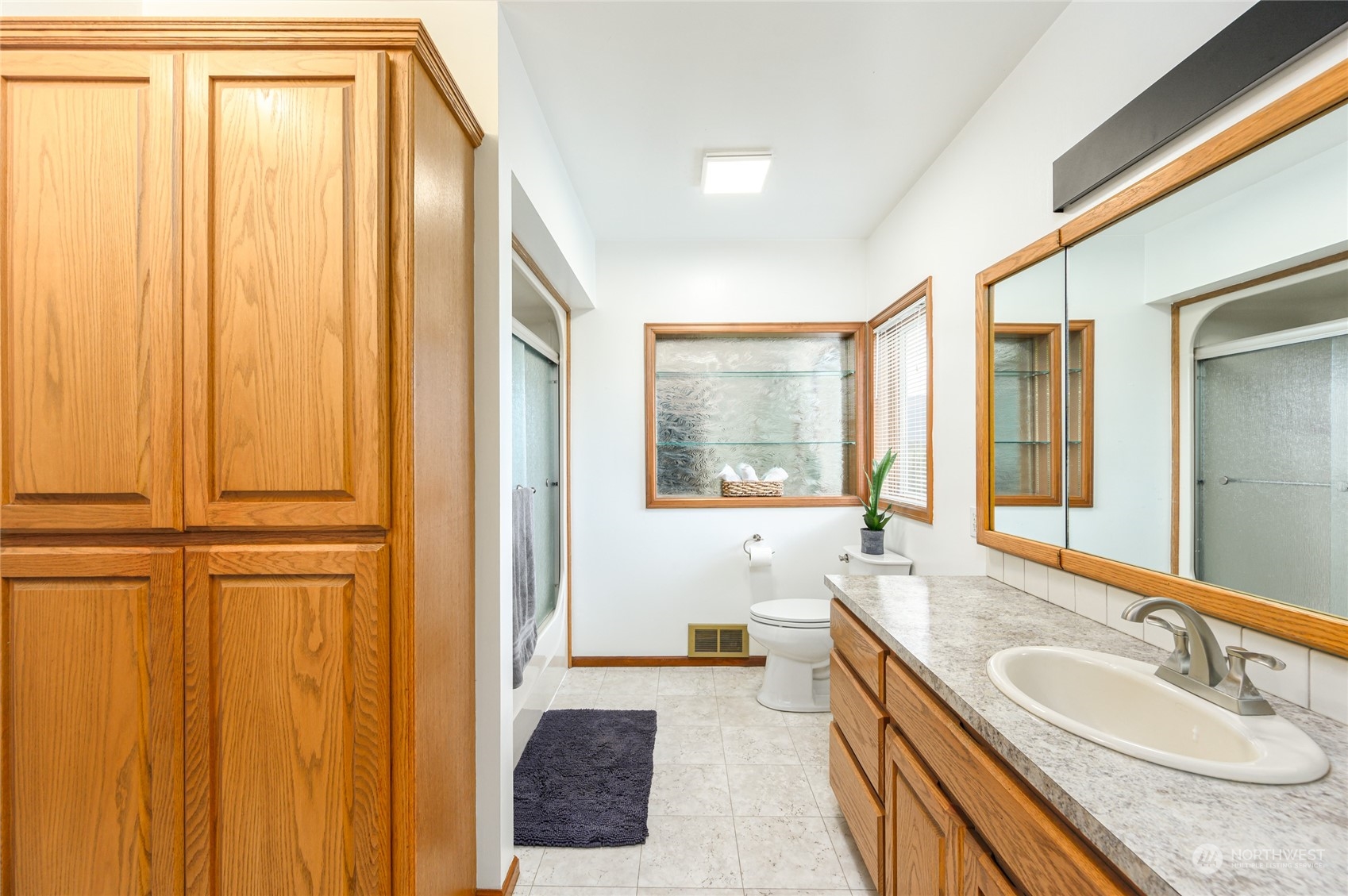 7956 Trapline Road Everson, WA 98247 - Photo 20 of 40 a spacious bathroom with a granite countertop sink and a large mirror