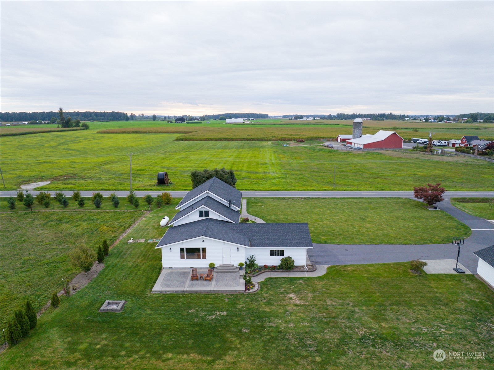 7956 Trapline Road Everson, WA 98247 - Photo 30 of 40 a front view of a house with a big yard and potted plants