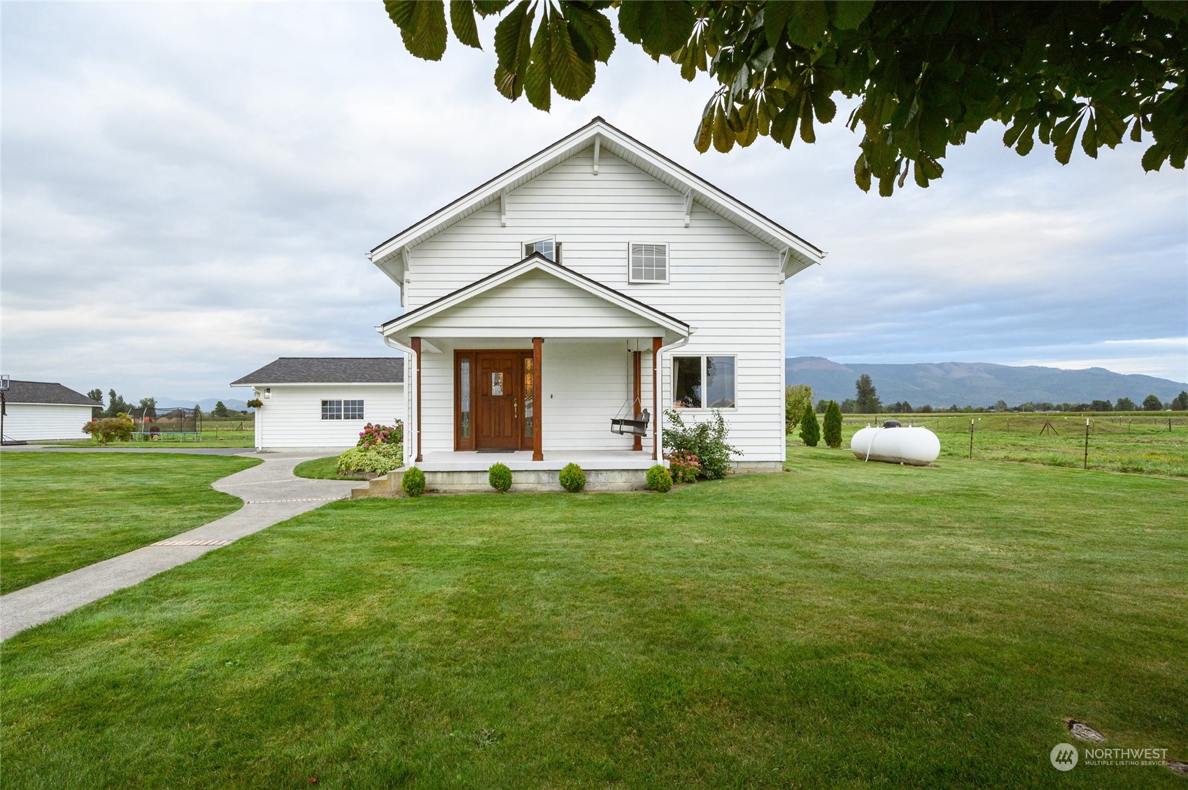 7956 Trapline Road Everson, WA 98247 - Photo 3 of 40 a front view of a house with a garden and porch