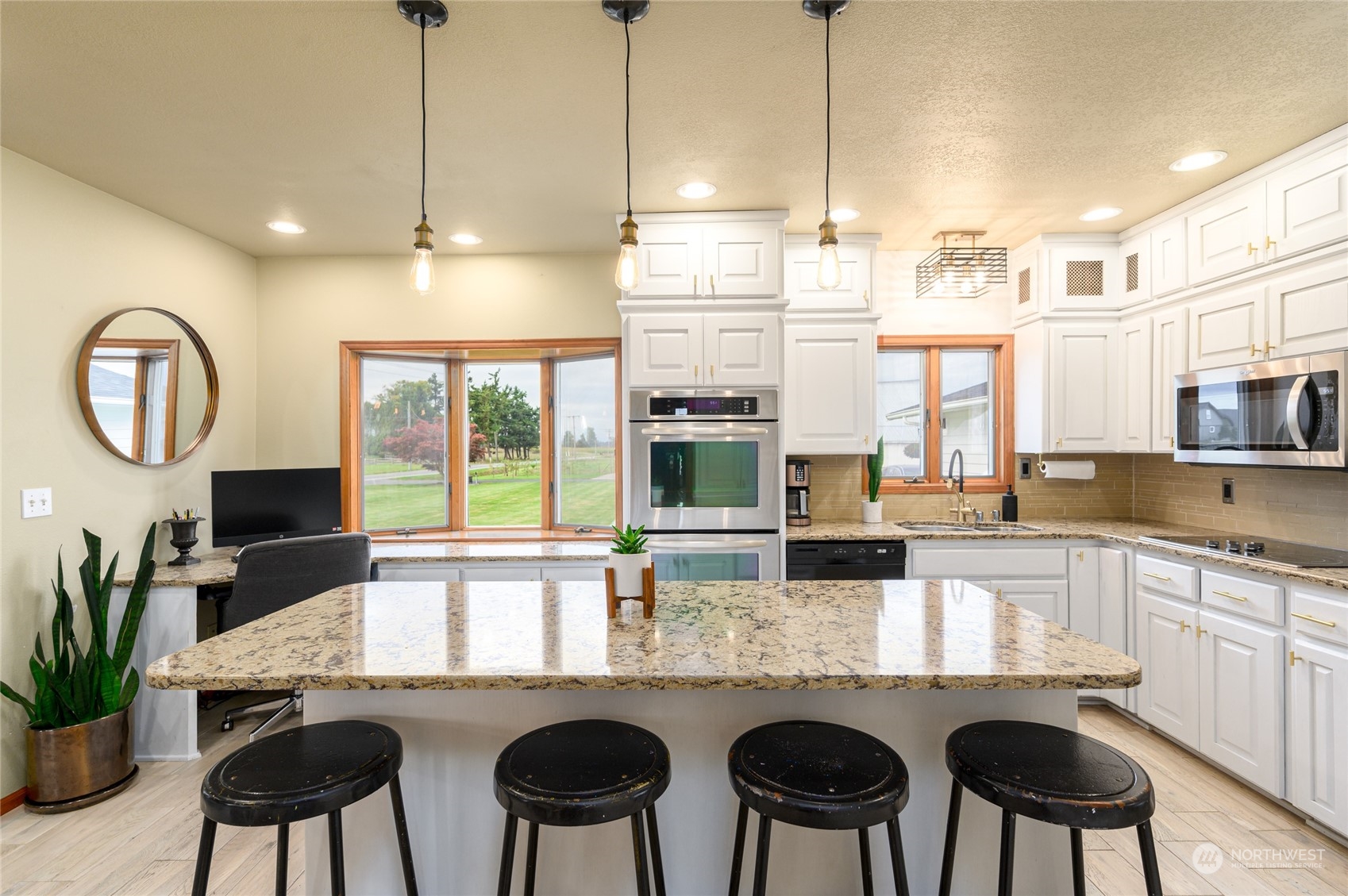 7956 Trapline Road Everson, WA 98247 - Photo 9 of 40 a kitchen with granite countertop a table and chairs in it