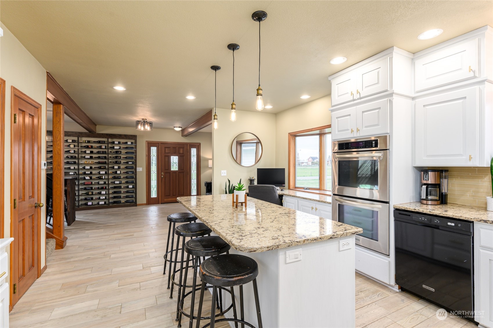 7956 Trapline Road Everson, WA 98247 - Photo 10 of 40 a large kitchen with granite countertop a large kitchen island a sink stainless steel appliances and cabinets