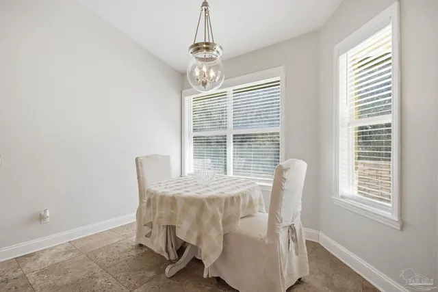 a view of a dining room with furniture and window