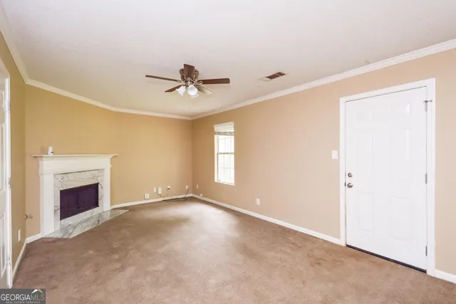 a view of empty room with a fireplace