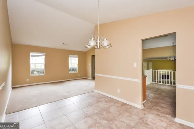 a view of a room with window and chandelier