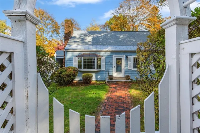 a view of a house with backyard and sitting area