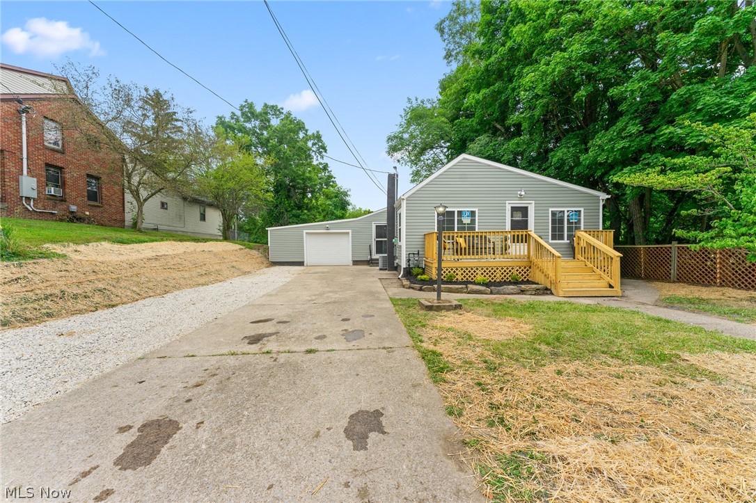 3568 McCartney Road Youngstown, OH 44505 - Photo 29 of 29 View of front facade featuring a front yard, an outdoor structure, a deck, and a garage