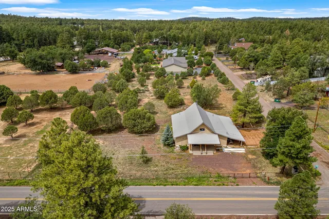 a view of a house with a yard and lake view