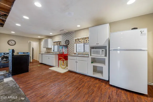 a kitchen with stainless steel appliances a refrigerator sink and wooden cabinets