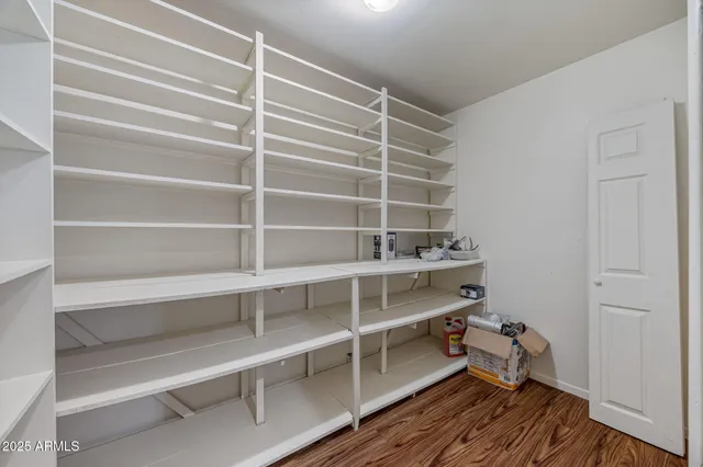 a view of walk in closet with empty racks
