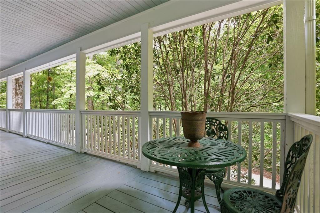 3259 Etchison Road Loganville, GA 30052 - Photo 37 of 50 a view of a balcony with table and chairs