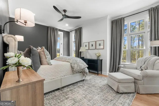 a bedroom with a bed couch and window