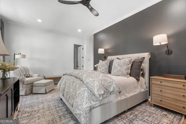 a spacious bedroom with a bed and a lamp