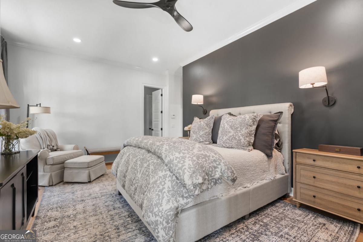 1951 Tru Fail Crossing Road Garfield, GA 30425 - Photo 12 of 49 a spacious bedroom with a bed and a lamp
