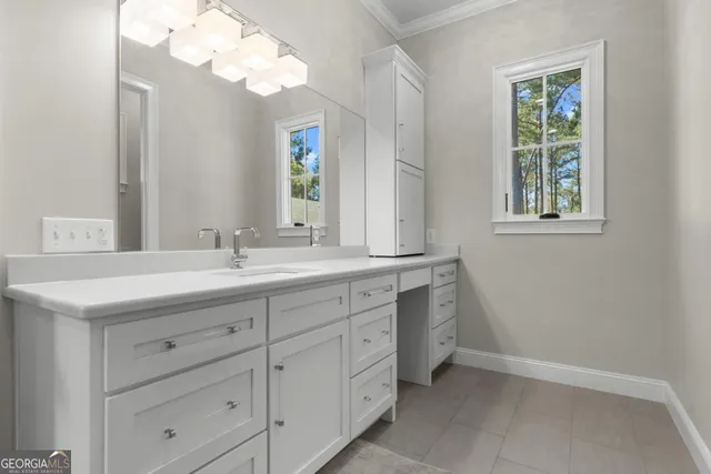 a bathroom with a sink a vanity and a mirror