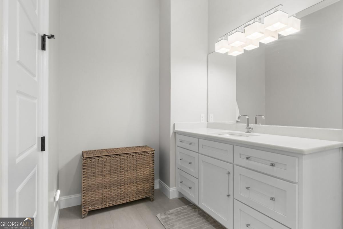 1951 Tru Fail Crossing Road Garfield, GA 30425 - Photo 14 of 49 a bathroom with a sink a light fixture and a mirror