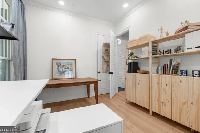 a living room with furniture and a book shelf