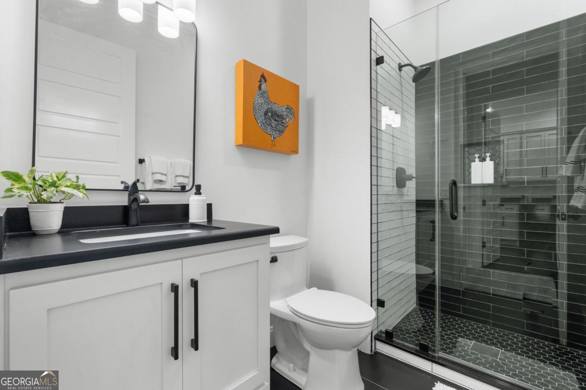 1951 Tru Fail Crossing Road Garfield, GA 30425 - Photo 18 of 49 a bathroom with a sink a toilet a shower and a mirror