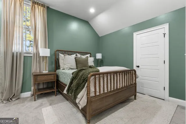 a bed sitting in a bedroom next to a window