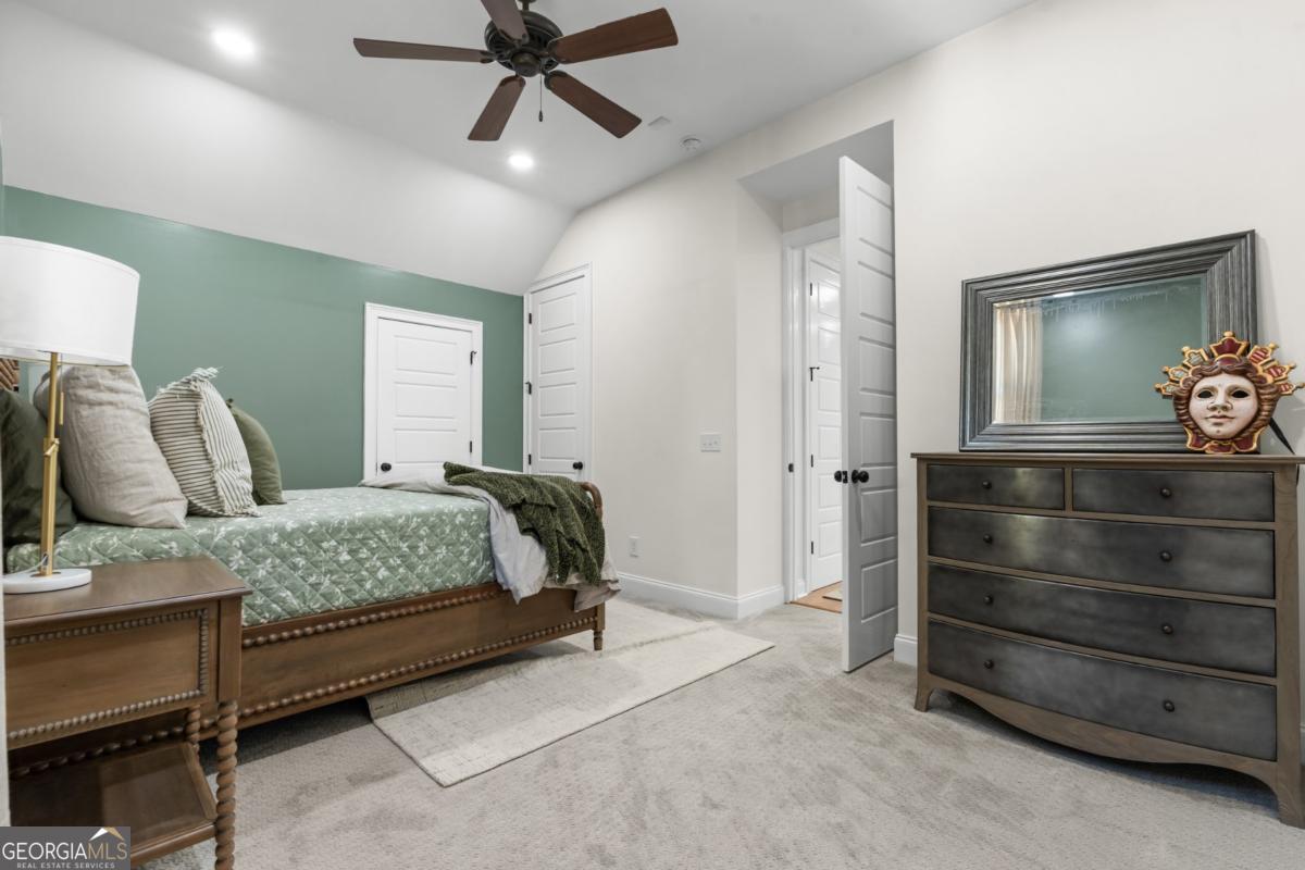 1951 Tru Fail Crossing Road Garfield, GA 30425 - Photo 20 of 49 a bedroom with a bed and a chandelier