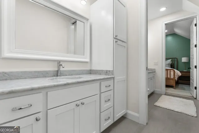 a en suite bathroom with a sink and mirror