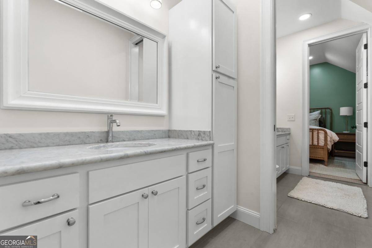 1951 Tru Fail Crossing Road Garfield, GA 30425 - Photo 24 of 49 a en suite bathroom with a sink and mirror