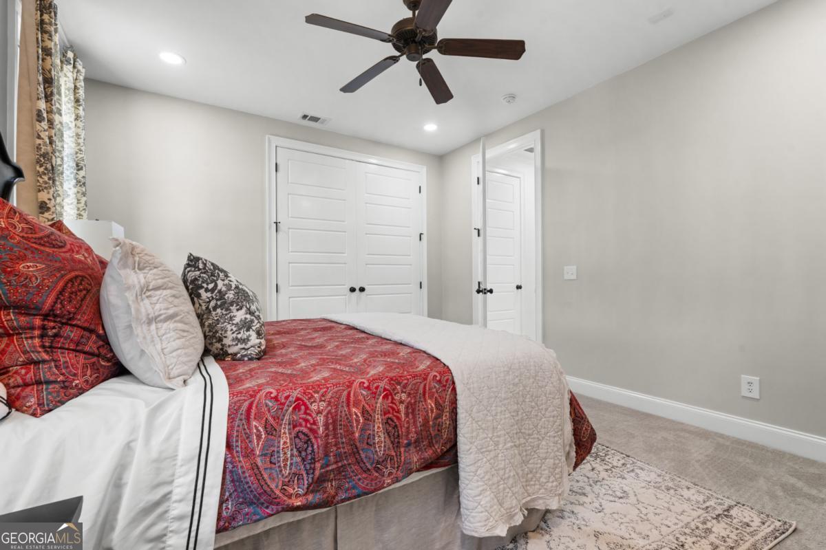 1951 Tru Fail Crossing Road Garfield, GA 30425 - Photo 25 of 49 a bedroom with a bed and a chandelier