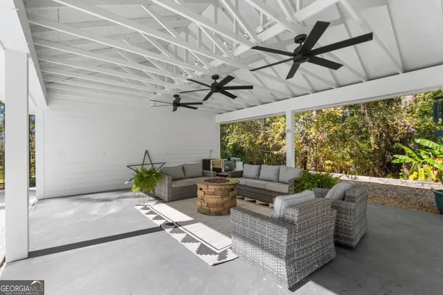 a living room with furniture and a floor to ceiling window