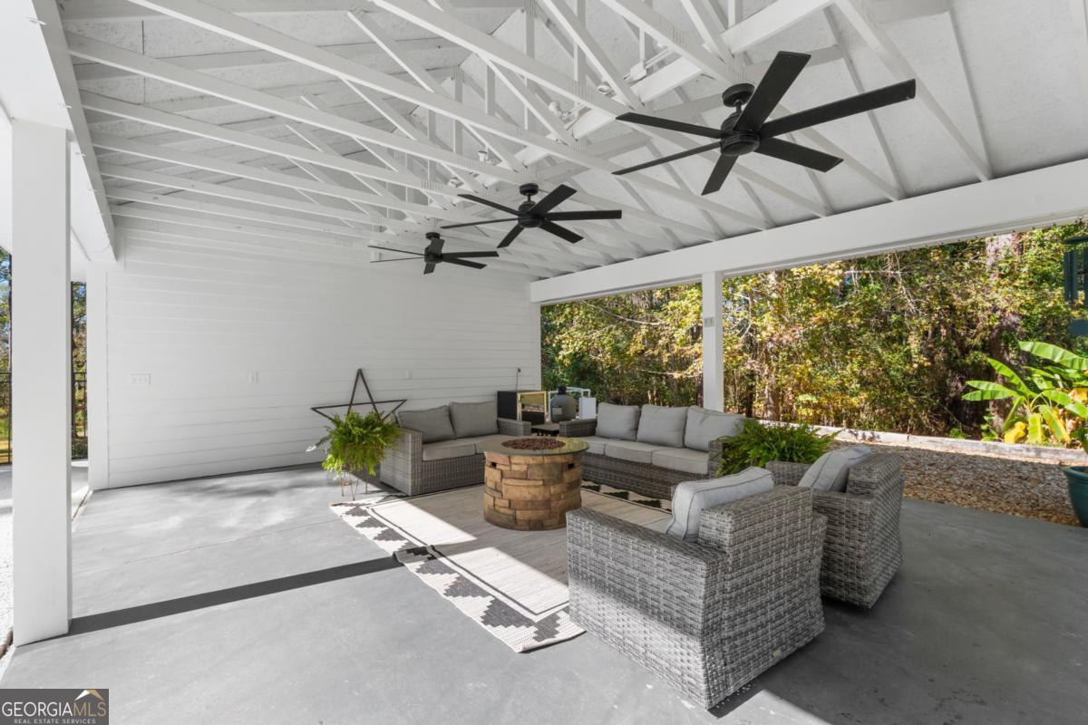 1951 Tru Fail Crossing Road Garfield, GA 30425 - Photo 34 of 49 a living room with furniture and a floor to ceiling window