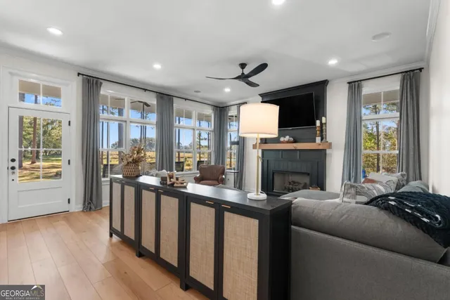 a living room with furniture a fireplace and a flat screen tv