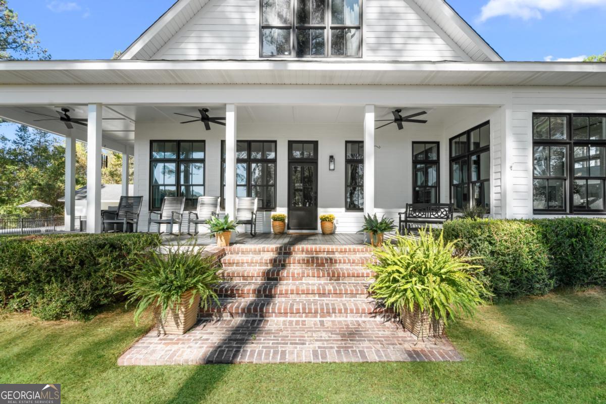 1951 Tru Fail Crossing Road Garfield, GA 30425 - Photo 42 of 49 a view of a patio with table and chairs potted plants and large tree