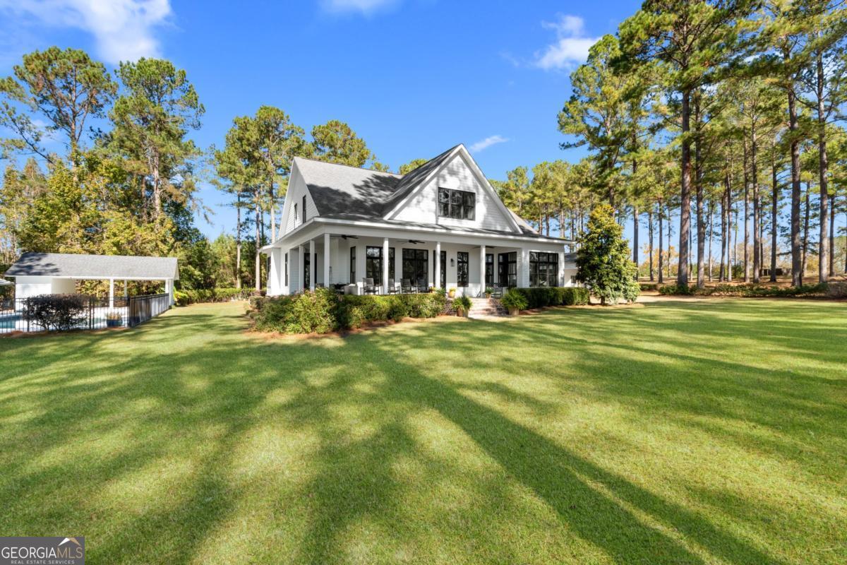 1951 Tru Fail Crossing Road Garfield, GA 30425 - Photo 43 of 49 a front view of a house with a garden