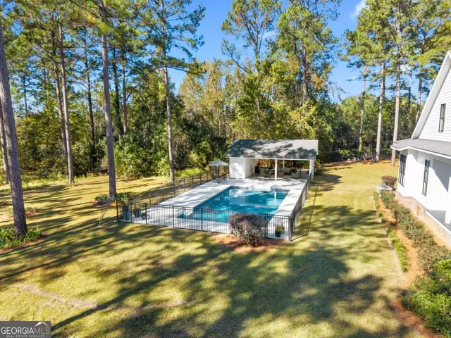 an aerial view of a house with a yard