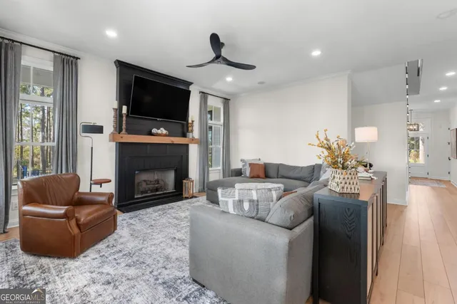 a living room with furniture fireplace and flat screen tv