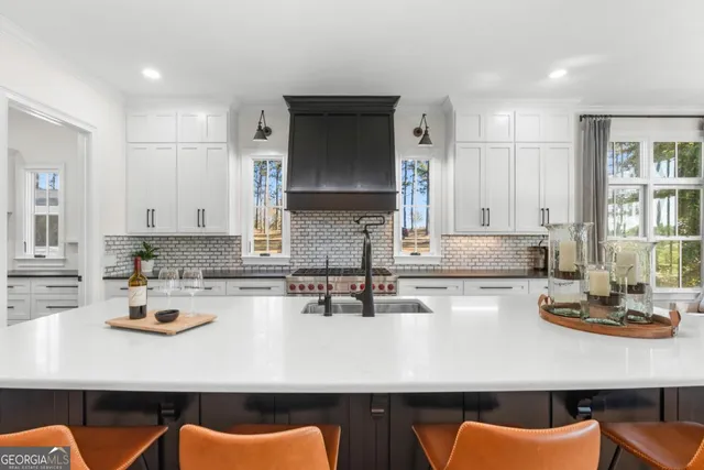 a kitchen with a sink a stove cabinets and counter space