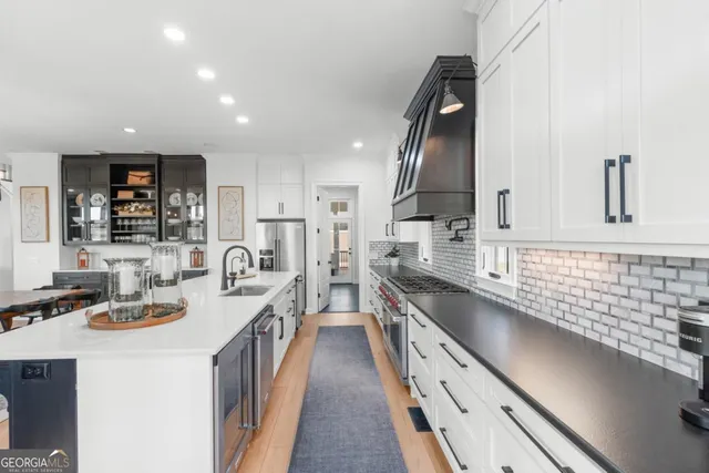 a kitchen with counter top space a sink and appliances