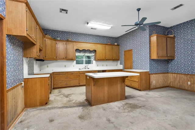 a kitchen with stainless steel appliances granite countertop a sink a stove and a refrigerator