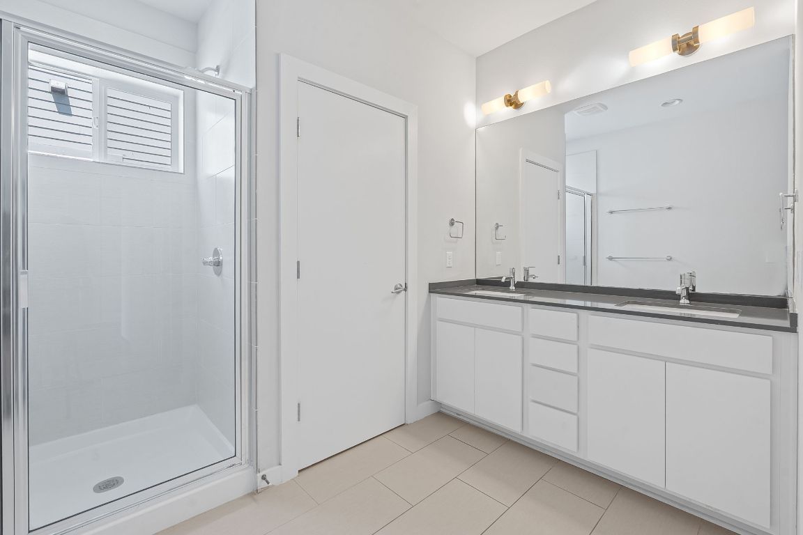 301 West Stassney Lane, Unit 7 Austin, TX 78745 - Photo 18 of 30 a bathroom with a granite countertop sink and a mirror